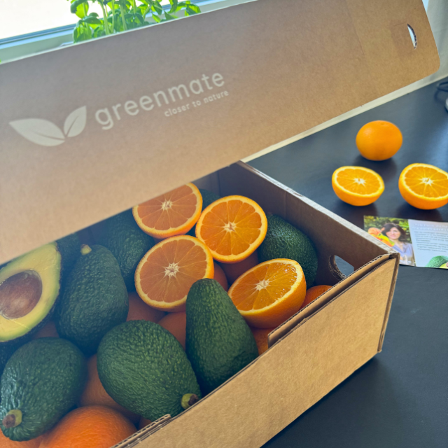 box with organic oranges and avocados