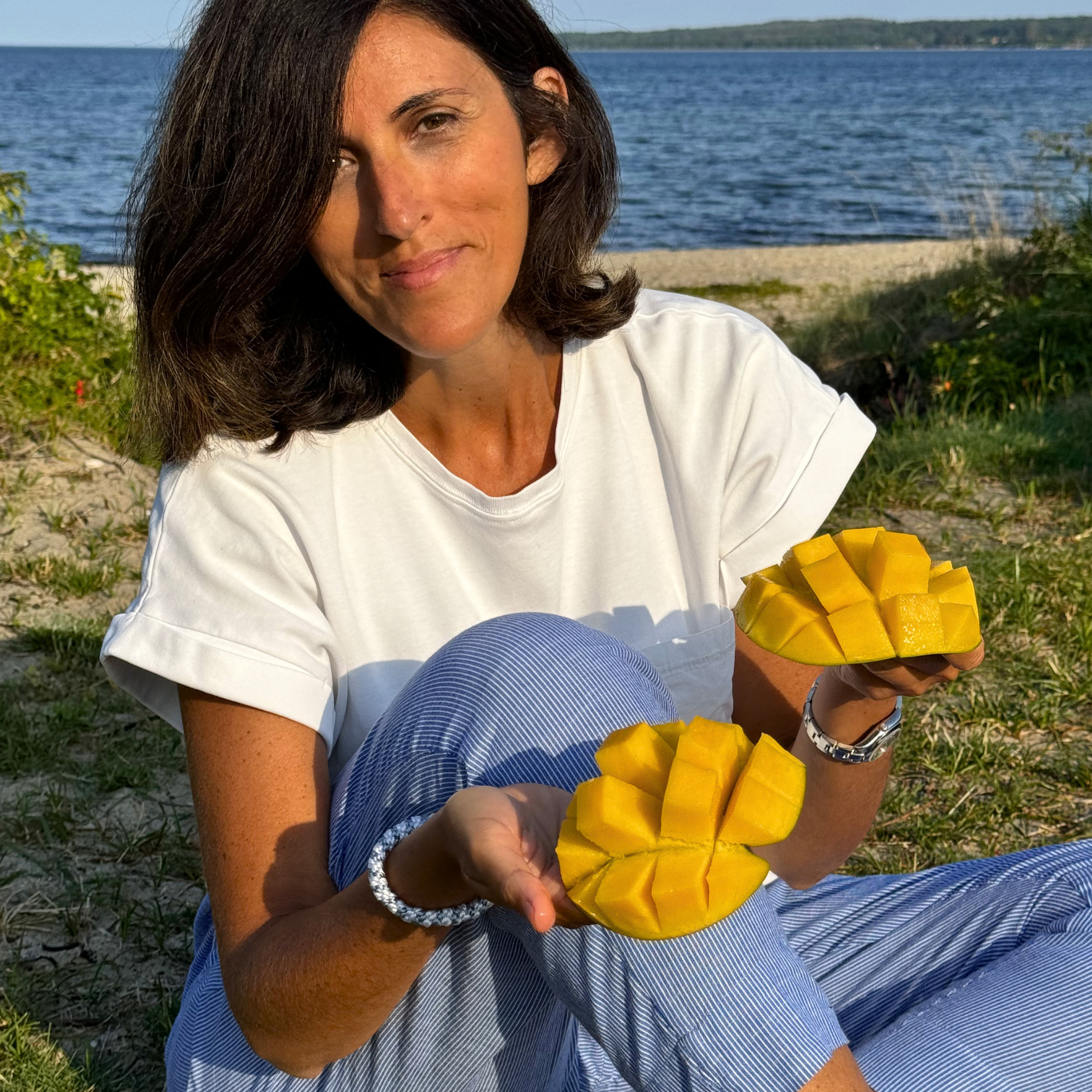 Woman with mangos at the beach
