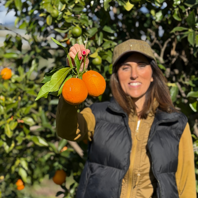 Woman with oranges in one hand
