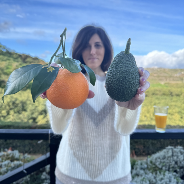 Woman with a big orange and avocado