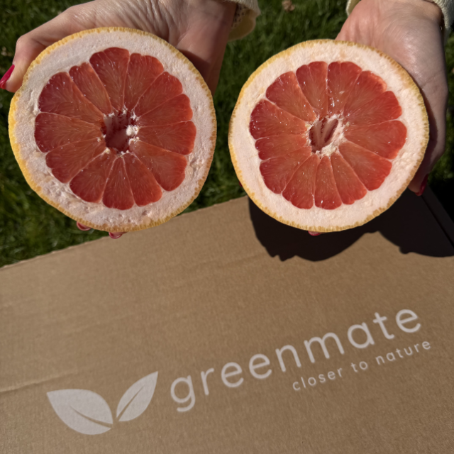 to hænder viser grapefrugter på en papkasse fra Greenmate
